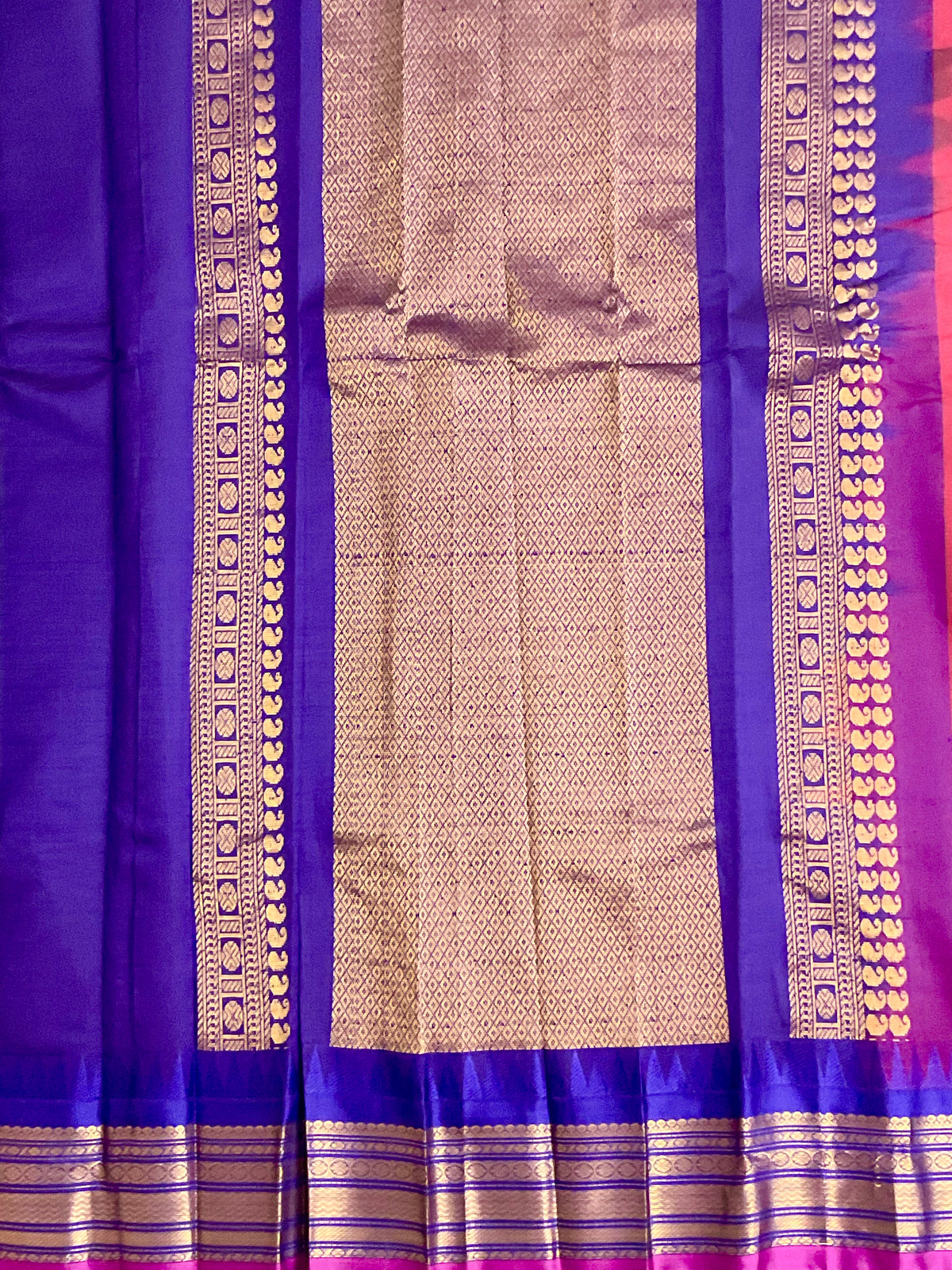 Draped red Gadwal silk saree with purple border and golden zari