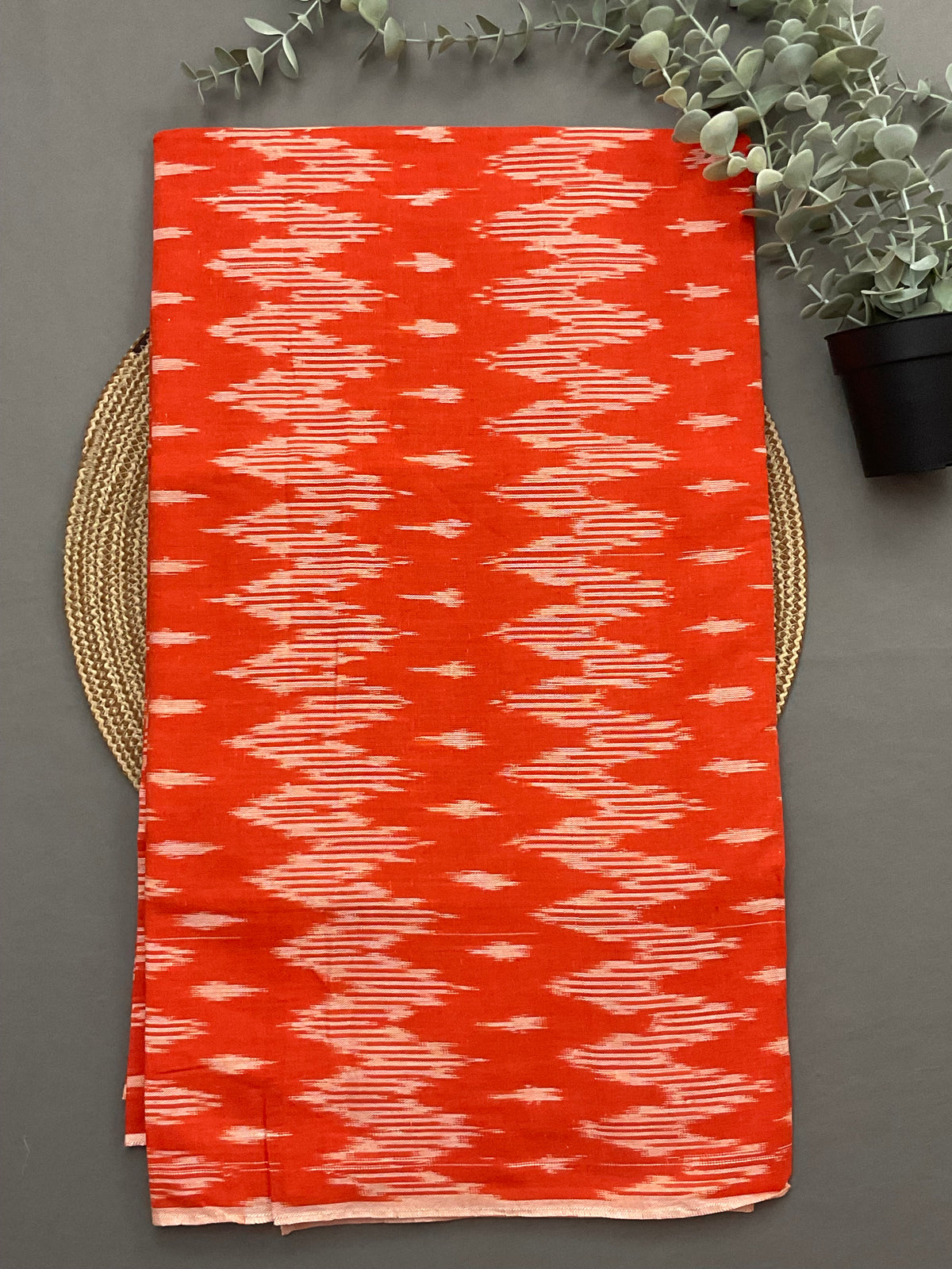 Orange handwoven Pochampally ikkat cotton top fabric close up