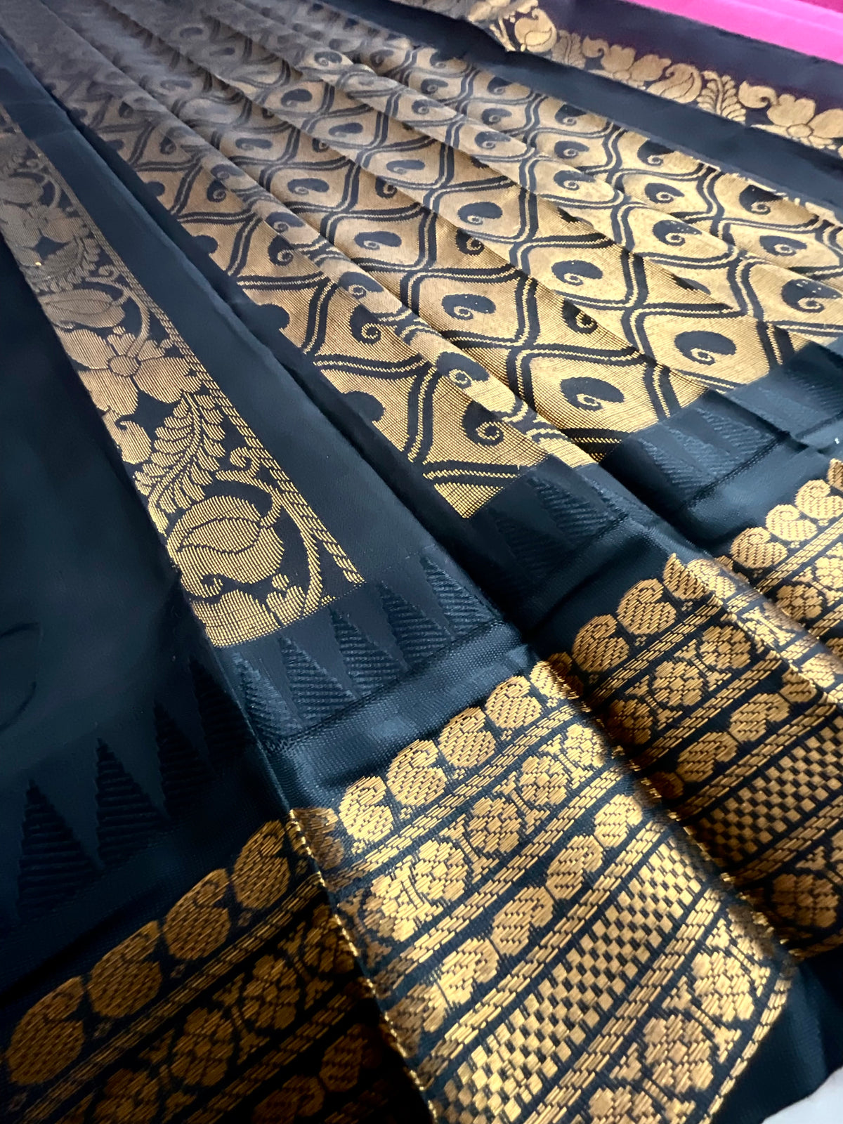 Golden zari border detail on pink and black Gadwal saree