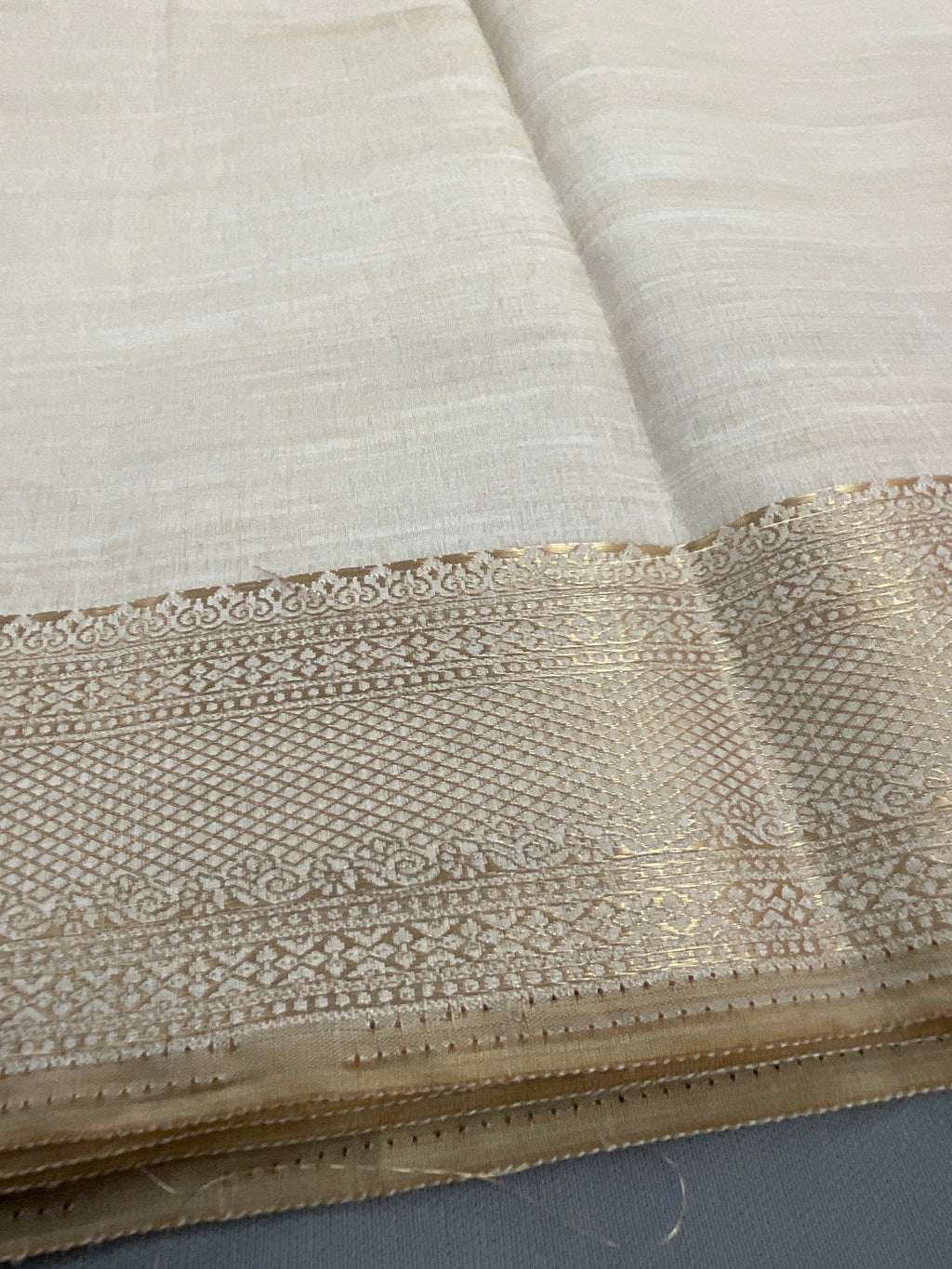 White and gold South Indian silk saree with zari pallu
