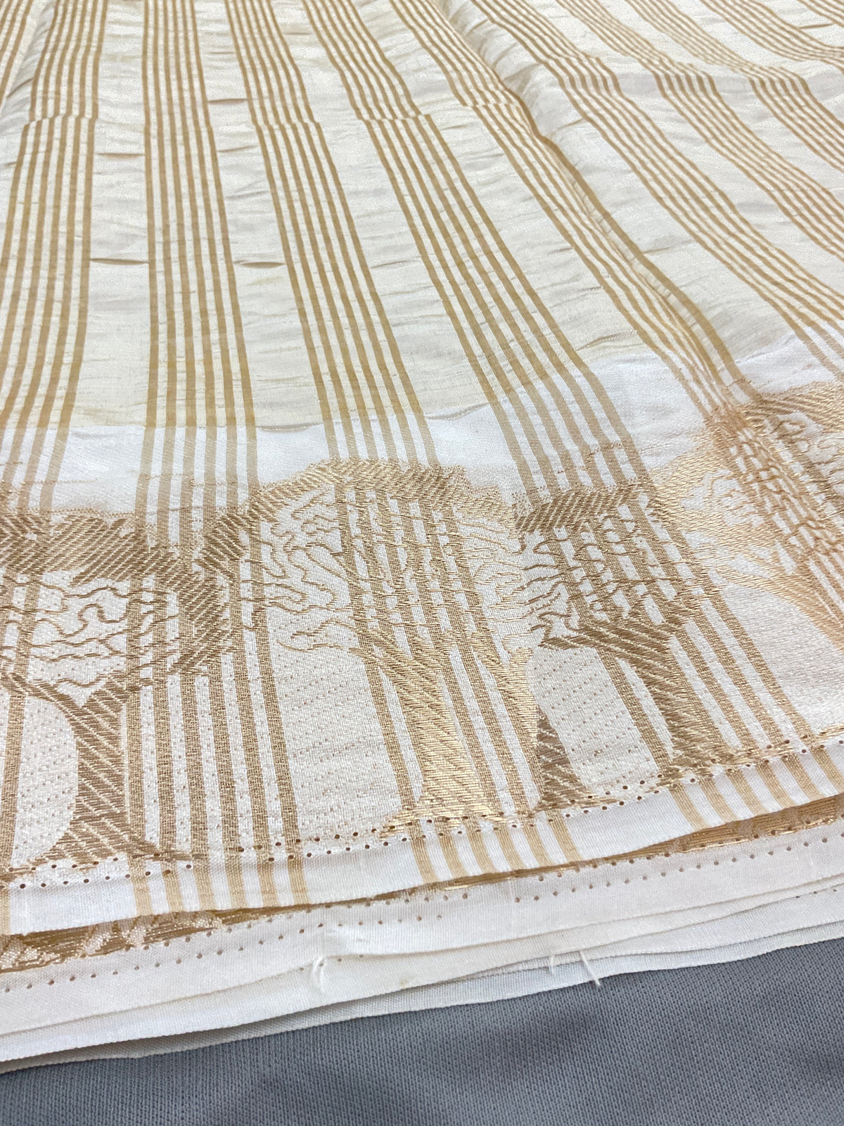 White and gold silk saree with designer border