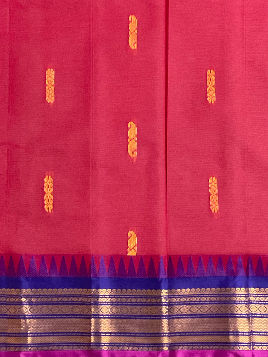 Golden zari border detail on red and purple Gadwal saree