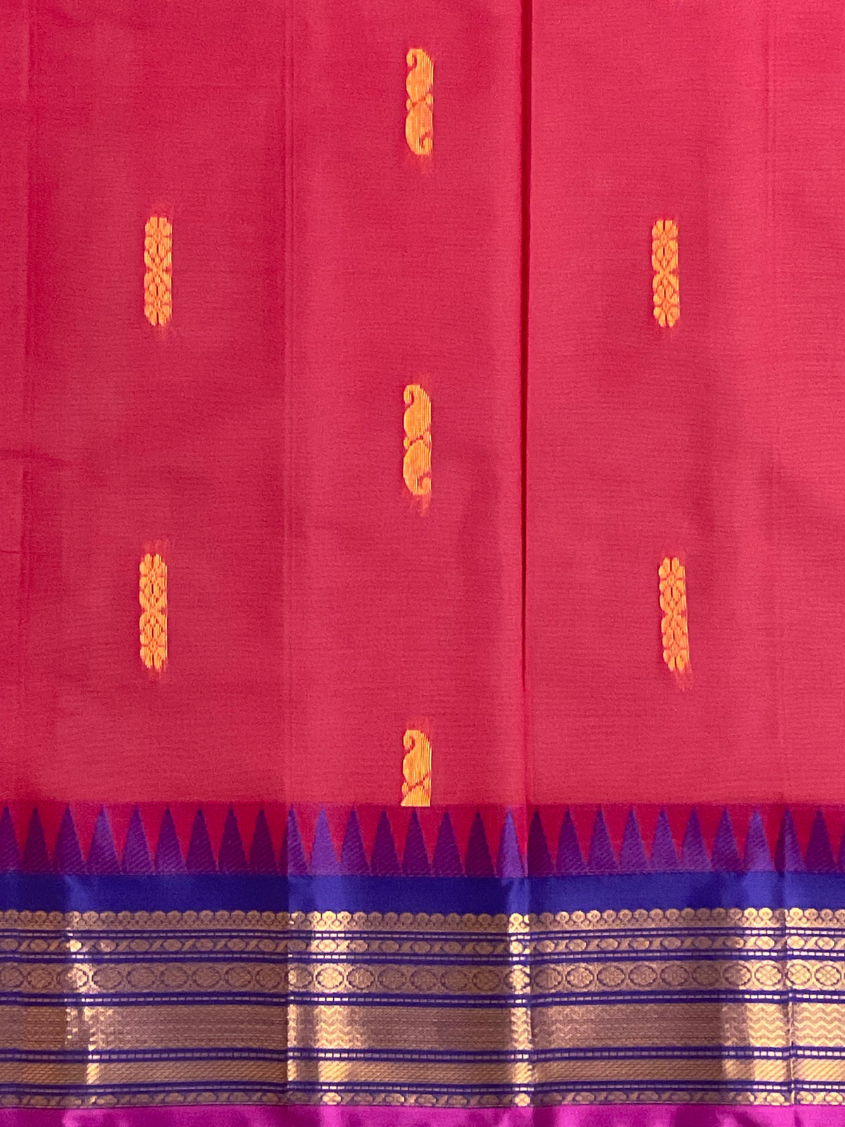 Golden zari border detail on red and purple Gadwal saree