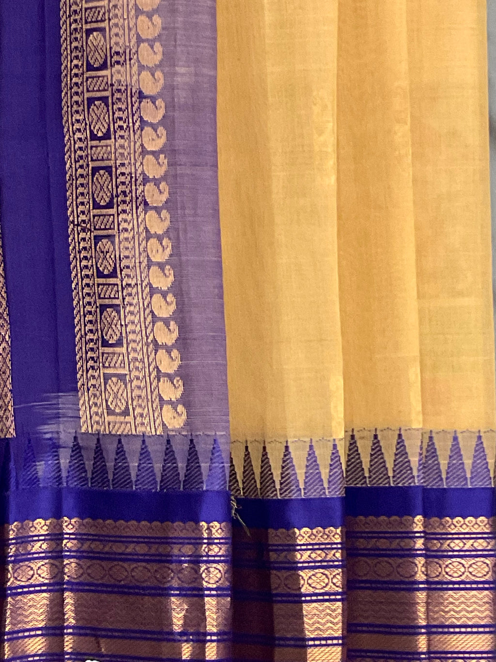 Violet silk pallu and golden zari of the cream Gadwal silk saree