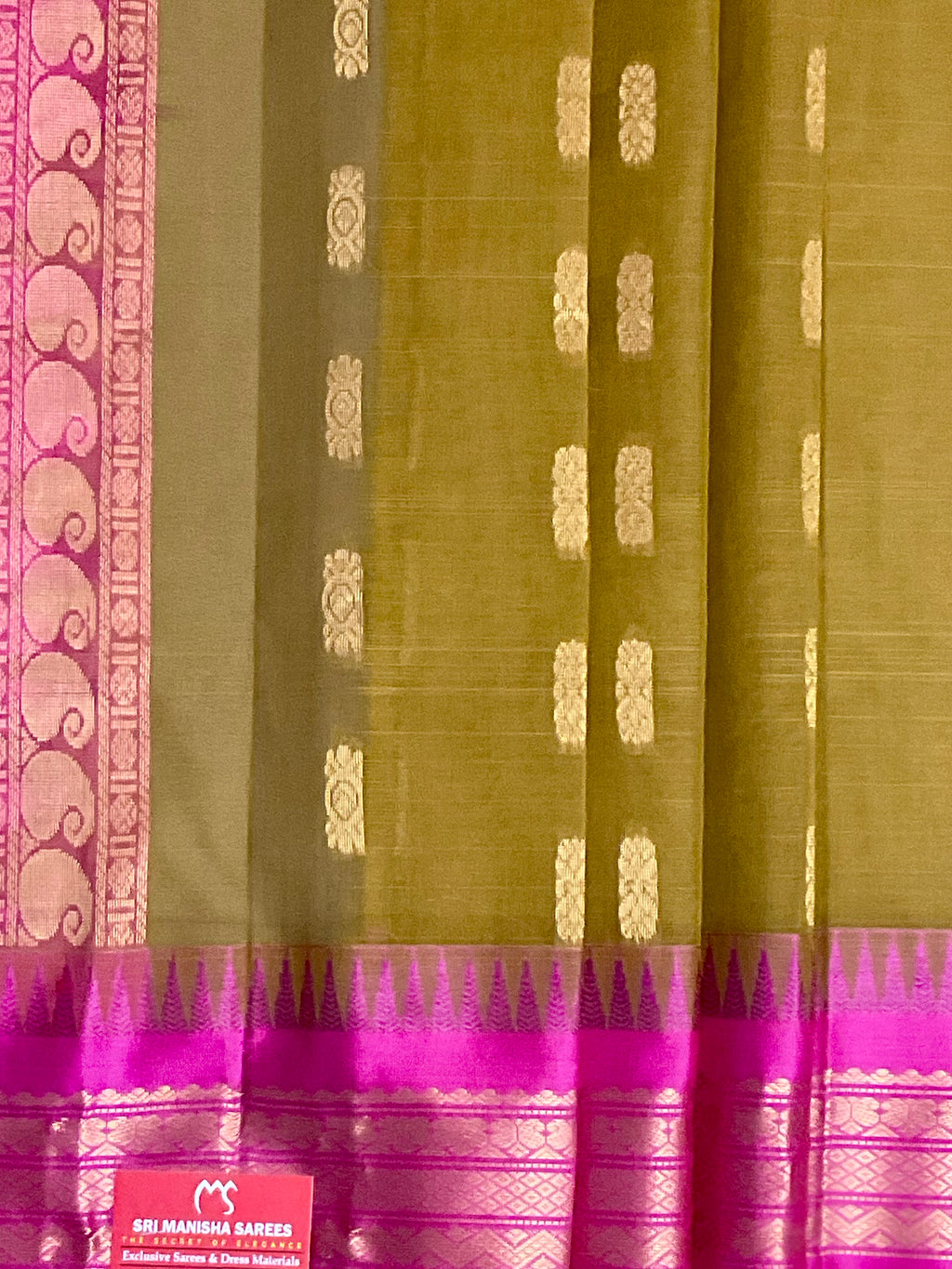 Pink silk pallu and golden zari on mehendi green Gadwal saree