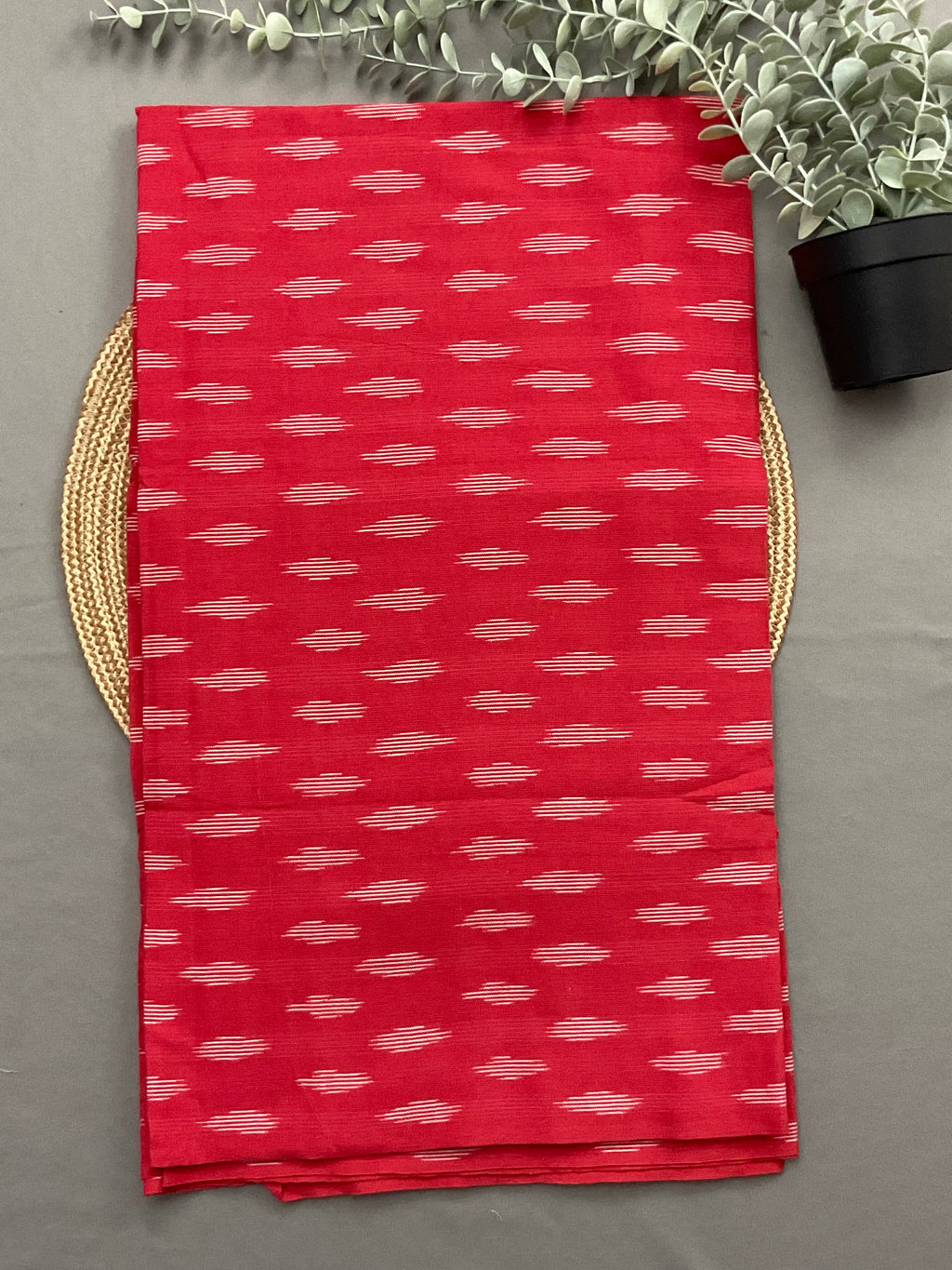 Red handwoven Pochampally ikkat cotton top fabric close up