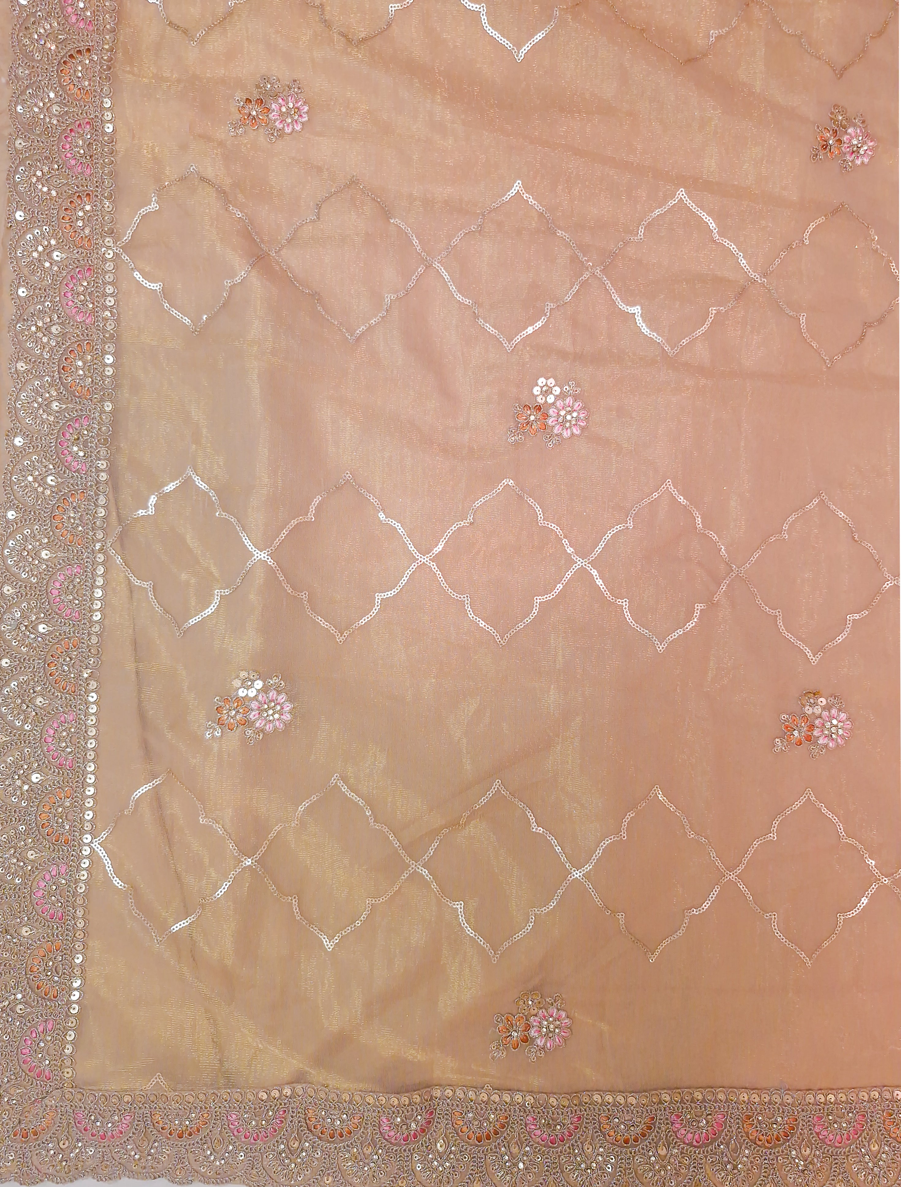 A peach-beige sheer dupatta or scarf with white embroidered geometric lattice patterns, small pink and gold floral motifs, and a heavily embellished border.