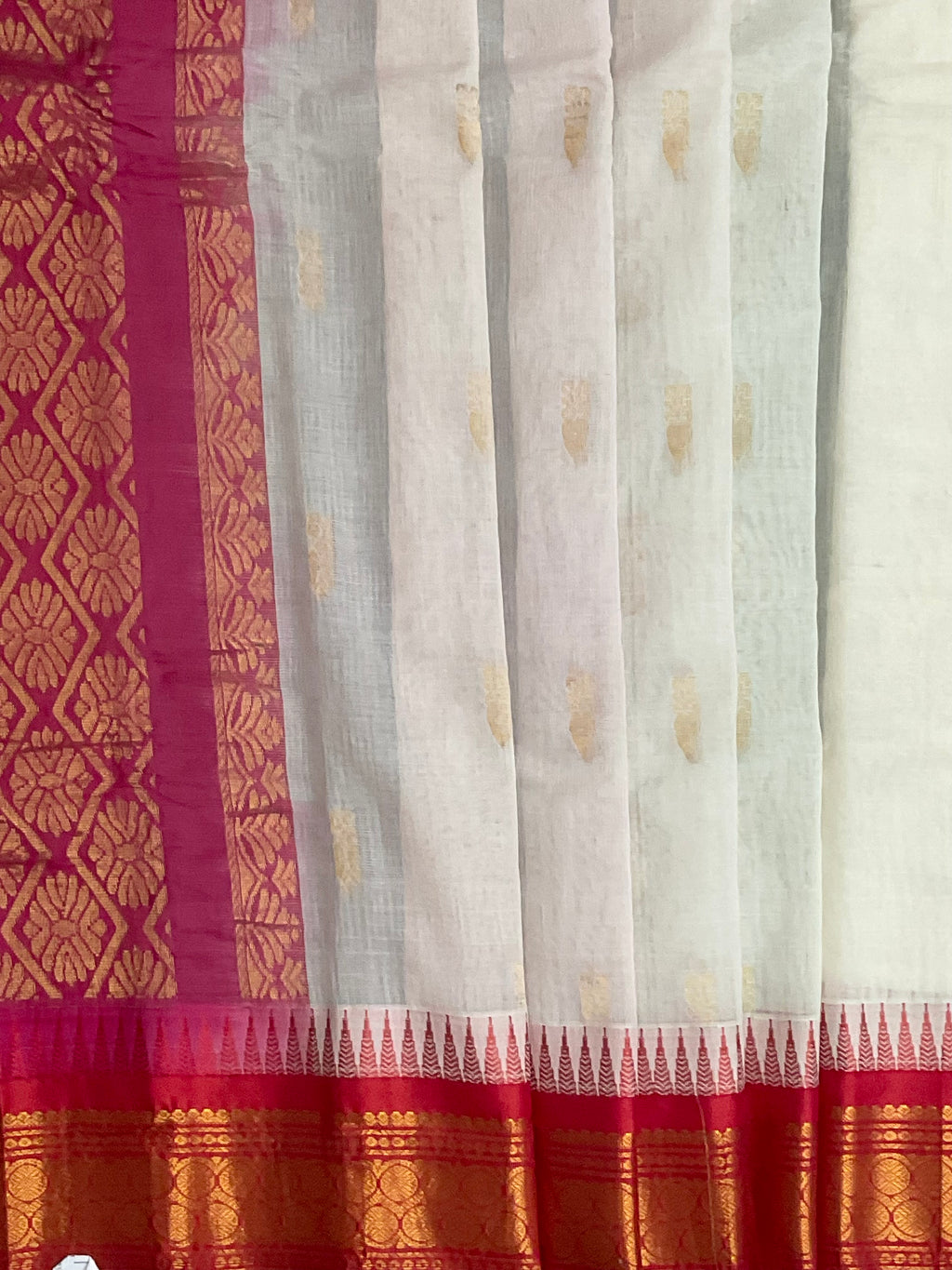 Reddish-pink silk pallu and golden zari on white Gadwal saree