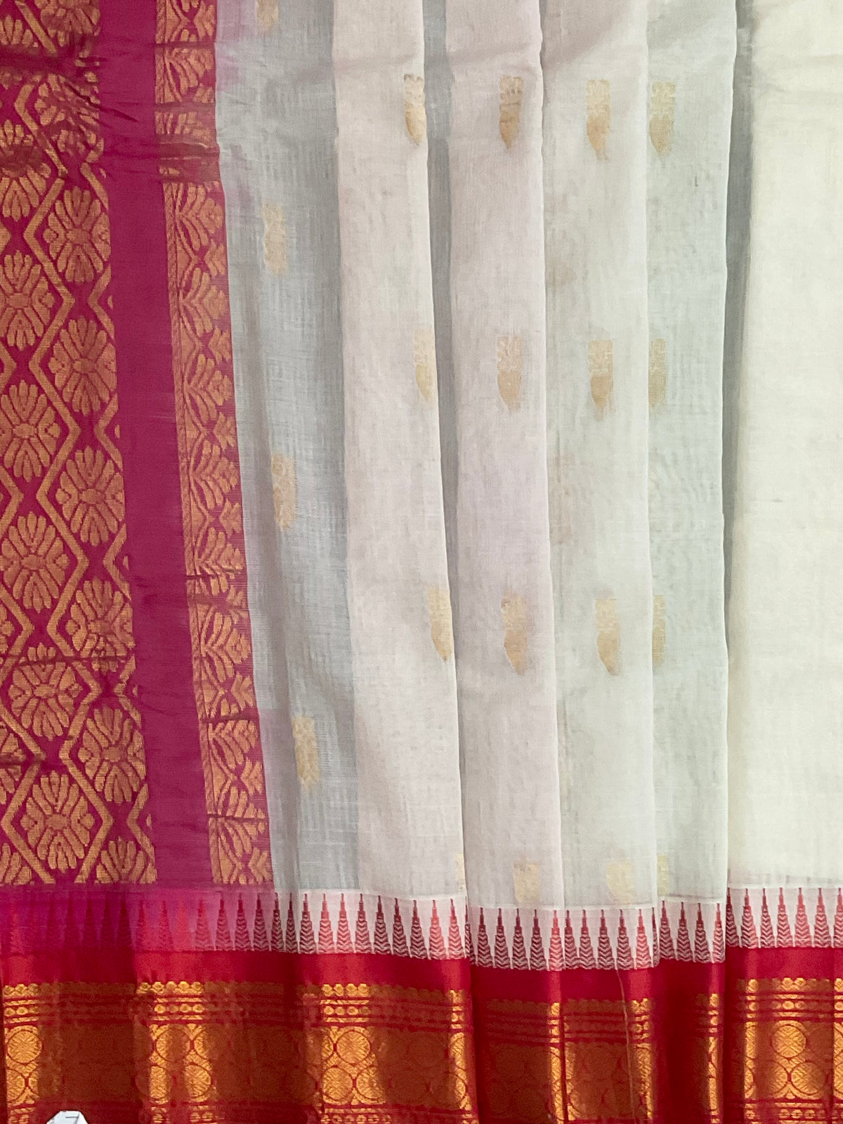 Reddish-pink silk pallu and golden zari on white Gadwal saree