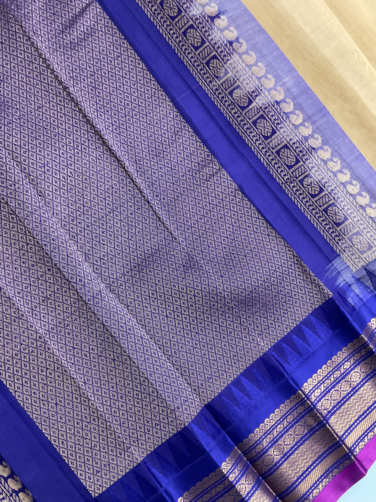 Draped cream Gadwal silk saree with violet border and golden zari