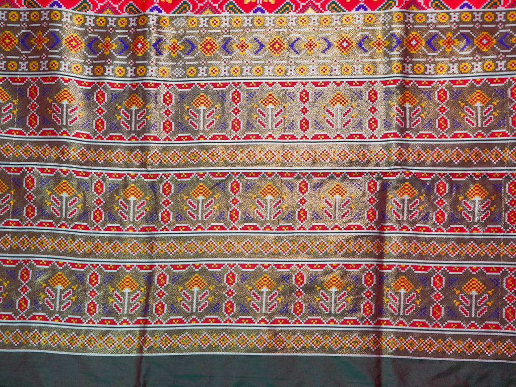 Patterned fabric with geometric designs in red, blue, and yellow on a multicolored background